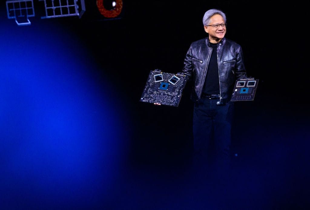 Nvidia CEO Jensen Huang smiling while presenting chips